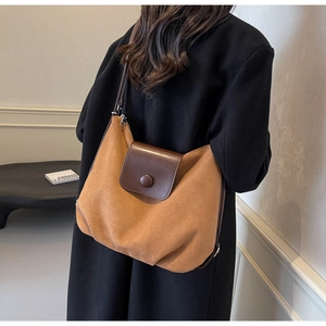 Macro detail of vintage brown suede tote bag featuring premium leather patchwork