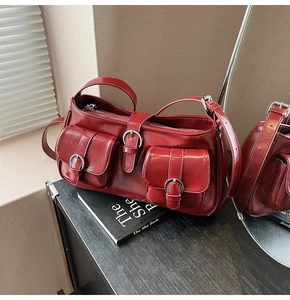 Detailansicht der dunkelroten glänzenden Ledertasche mit silbernen Schnallentaschen