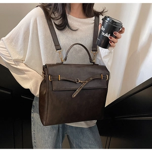 Detail view of the vintage brown leather backpack with adjustable straps and metal buckles
