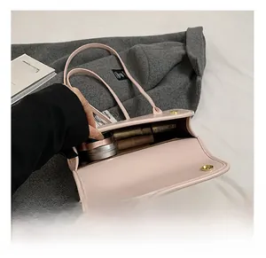 Detail view of pink leather handbag interior storage for lipstick and cosmetics