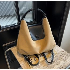 Detail of khaki suede versatile tote with black leather trim and vintage hardware