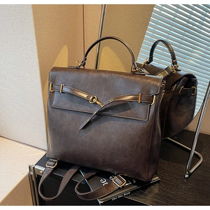 Detail of vintage dark brown backpack with gold metal buckles and smooth texture