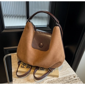 Detail of caramel suede and dark brown leather stitching on vintage large tote bag