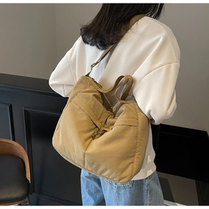 Back view of a khaki nylon tote bag showing its large capacity and soft slouchy design