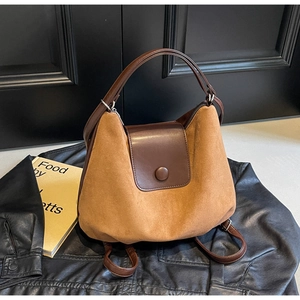 Close-up of caramel suede and brown leather texture on a versatile convertible backpack