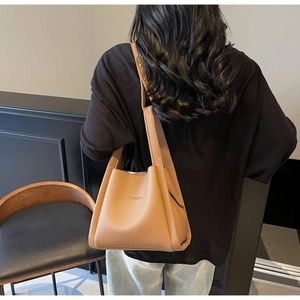 Close-up of caramel bucket bag featuring lychee grain texture and BALOSOO embossed logo
