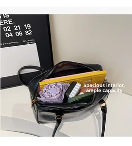 Spacious interior of a vintage black shoulder bag showing large capacity for daily items
