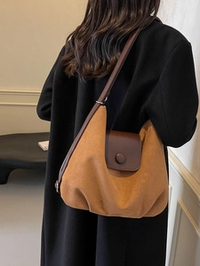 Retro large capacity tote bag in brown suede and leather shown on a model shoulder