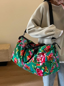 Large floral travel duffel bag with red peony print and adjustable shoulder strap