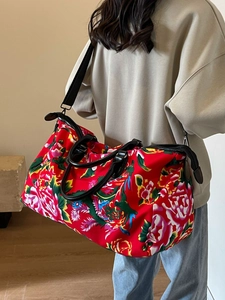 Ethnic style travel bag with red floral peony pattern and black leather handles