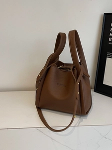 Brown lychee leather bucket bag with top handles and adjustable strap by BAMIROO
