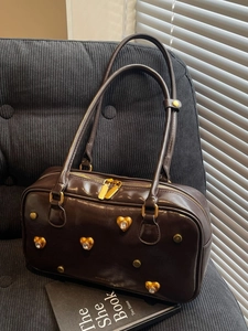 Deep brown glossy leather shoulder bag with gold heart studs and crystal accents