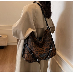 Detailed macro view of the leopard print hobo bag showing texture and silver buckles