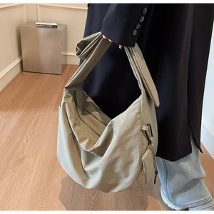 Large olive canvas crossbody bag with wide strap and detachable small square pouch