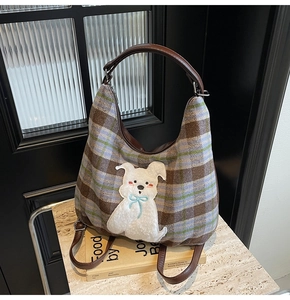 Close-up of retro plaid tote bag featuring a cute white cartoon dog embroidery detail