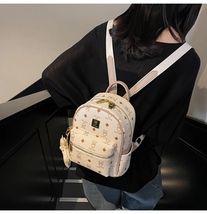 Close-up of mini teddy bear backpack with premium lychee grain PU leather texture