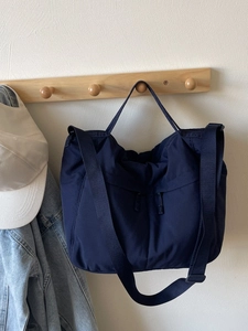 Large capacity navy blue nylon tote bag with dual front pockets and adjustable strap