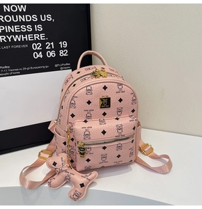 Pink mini backpack detail with bear pattern, metallic logo, and matching charm