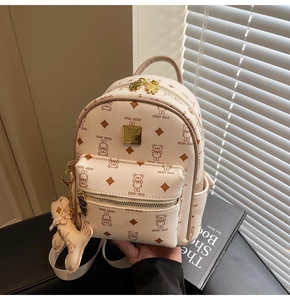 Detail of mini beige faux leather backpack with brown bear motifs and logo plaque