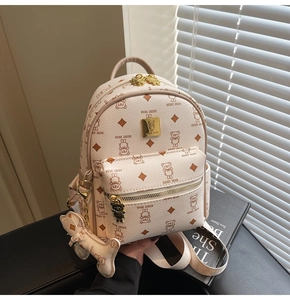 Detail of cream mini leather backpack with bear pattern, gold zippers and bone charm