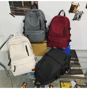 Detail view of multi-colored waterproof nylon backpacks with various zipper pockets