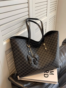 Large grey tote bag with monogram print, twin handles and a cute dog charm accessory