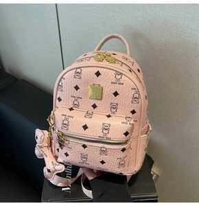 Pink pebbled leather backpack with teddy bear prints and gold bear charm detail