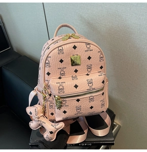 Detail of pink pebbled leather backpack with black bear pattern and gold bear charm