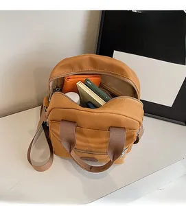 Detailed interior of khaki nylon crossbody bag showing storage space for phone and wallet