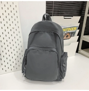Détail du sac à dos en nylon imperméable gris foncé avec poche zippée à l'avant