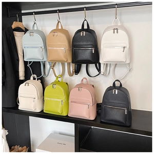 Detailed display of colorful mini backpacks in eight shades with lychee texture finish