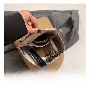 Detail view of spacious main compartment with zipper pocket in tan leather backpack