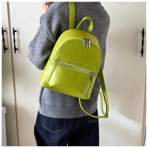 Detailed texture of lime green lychee leather on a chic minimalist mini backpack