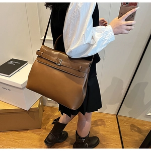 Detail view of large brown vintage leather tote bag with silver buckle and shoulder strap