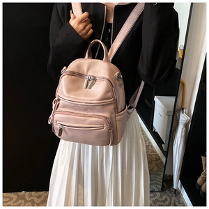 Detail view of pink PU leather mini backpack with multiple silver zipper pockets