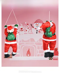 Detail of two climbing Santa Claus hanging ornaments with green gift bags for Christmas
