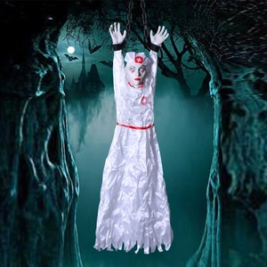 Close-up of a hanging scary zombie nurse with red cross and white tattered fabric