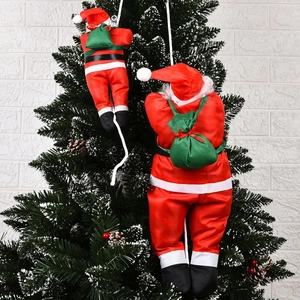 Climbing Santa Claus dolls with green gift bags hanging on a decorated Christmas tree