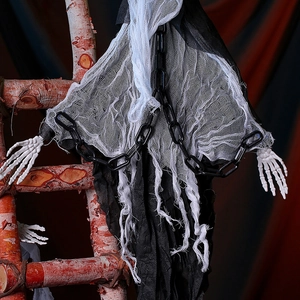 Detail view of hanging Halloween ghost prop with skull hands and black chains