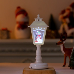 Detail of Christmas lantern with a snowman scene and dynamic swirling glitter inside