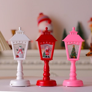 Detailed view of three festive musical Christmas lanterns with snowmen and Santa figurines