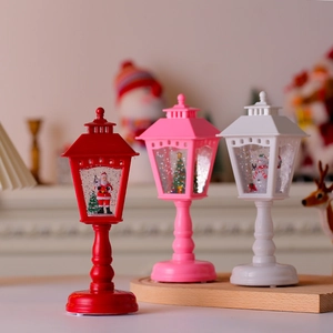 Three-piece Christmas lantern set with Santa, snowman and tree scenes in red, pink, and white