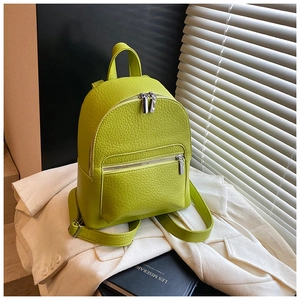 Side view of lime green pebbled leather backpack featuring silver zippers and adjustable straps