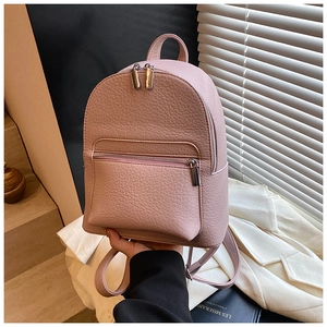 Close-up of light pink pebble grain leather backpack with silver zippers and top handle