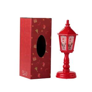 Red Christmas lantern with Santa Claus pattern and festive gift box packaging