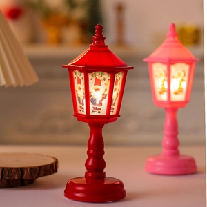 Close-up of retro Christmas LED lanterns with Santa Claus patterns and warm light
