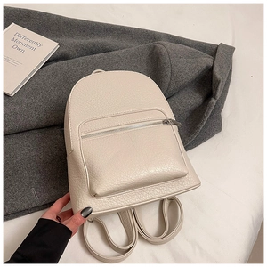 Close-up of off-white faux leather mini backpack with pebble grain and silver zipper