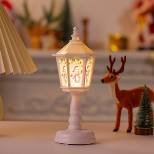 Close-up of white Christmas lantern with cute snowman illustration and warm LED lighting