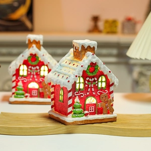 Luminous Christmas gingerbread house decoration with warm LED lights and resin snow details