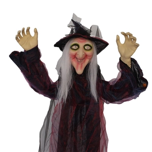 Detailed close-up of a Halloween witch prop with purple mesh robe and pointed wizard hat